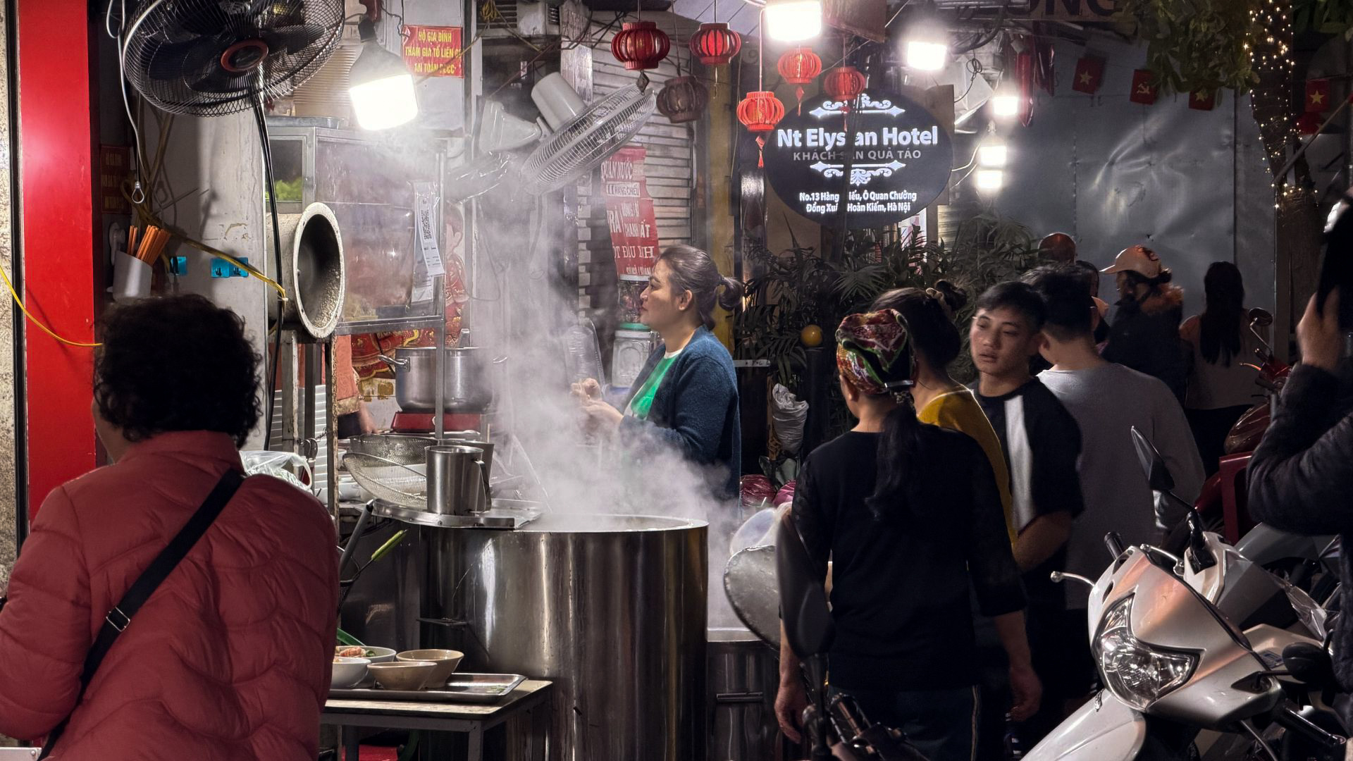 Street food vendor preparing food in Hanoi Old Quarter at night, Vietnam. Street food vendor preparing food in Hanoi Old Quarter at night, Vietnam.