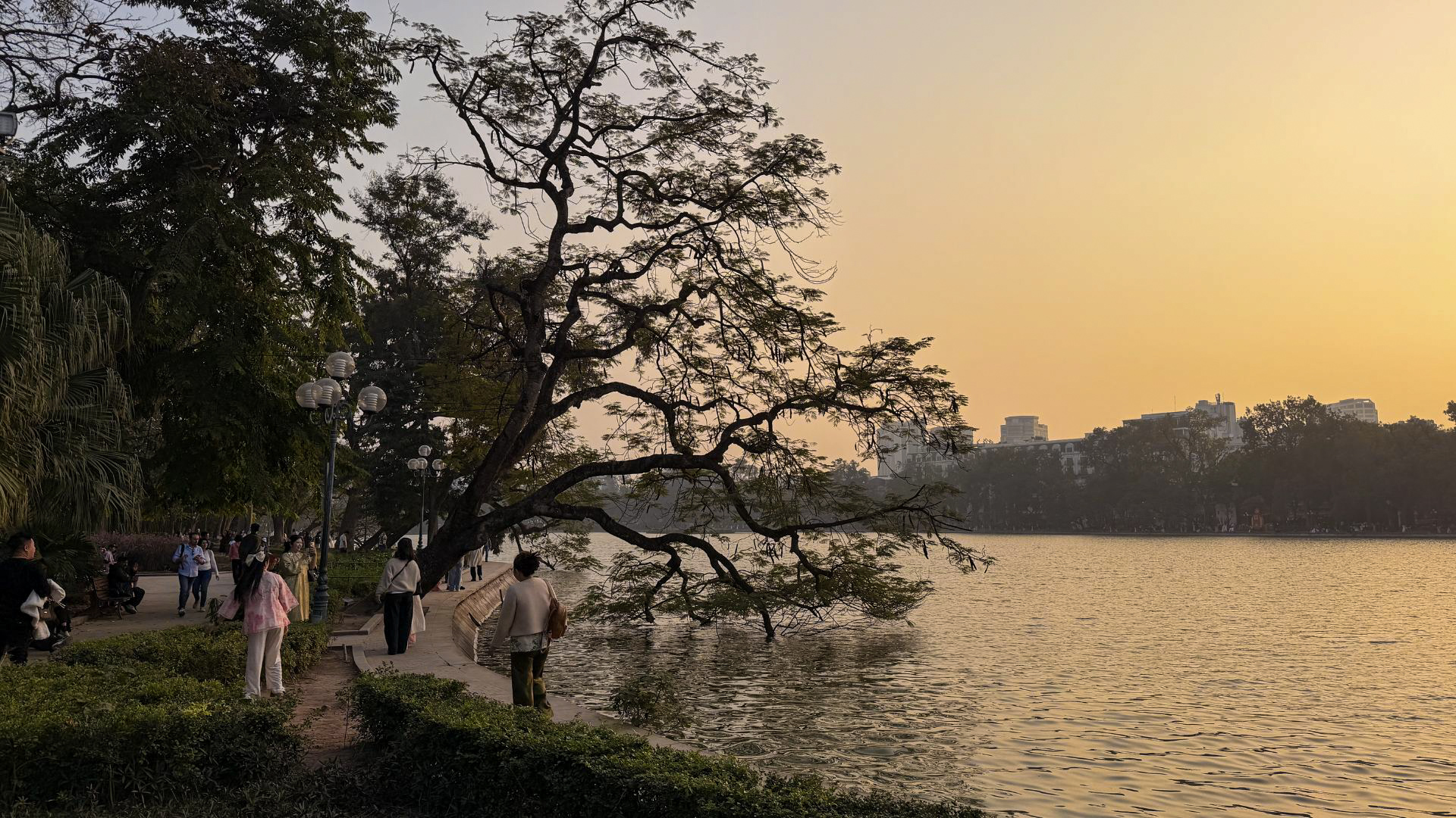 Visitors enjoying the sunset at Hoan Kiem Lake in Hanoi, Vietnam. Visitors enjoying the sunset at Hoan Kiem Lake in Hanoi, Vietnam.