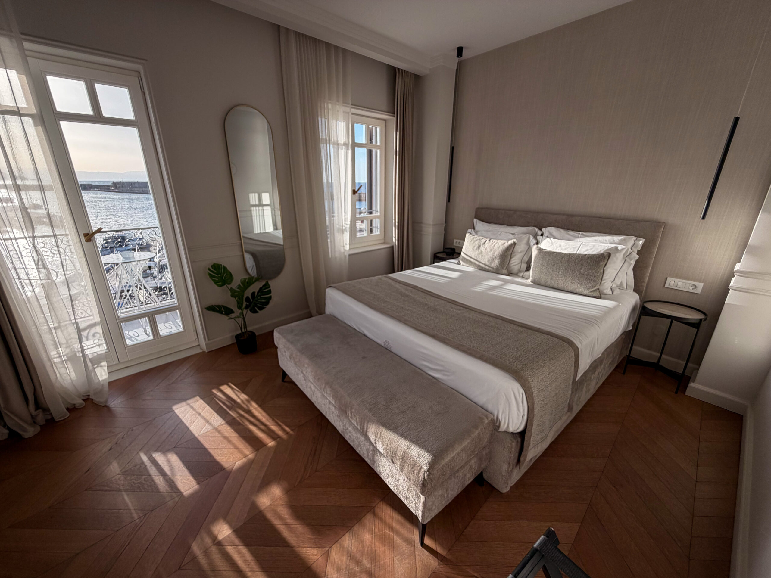 Bedroom with harbour view and balcony at Riviera Suites Chania