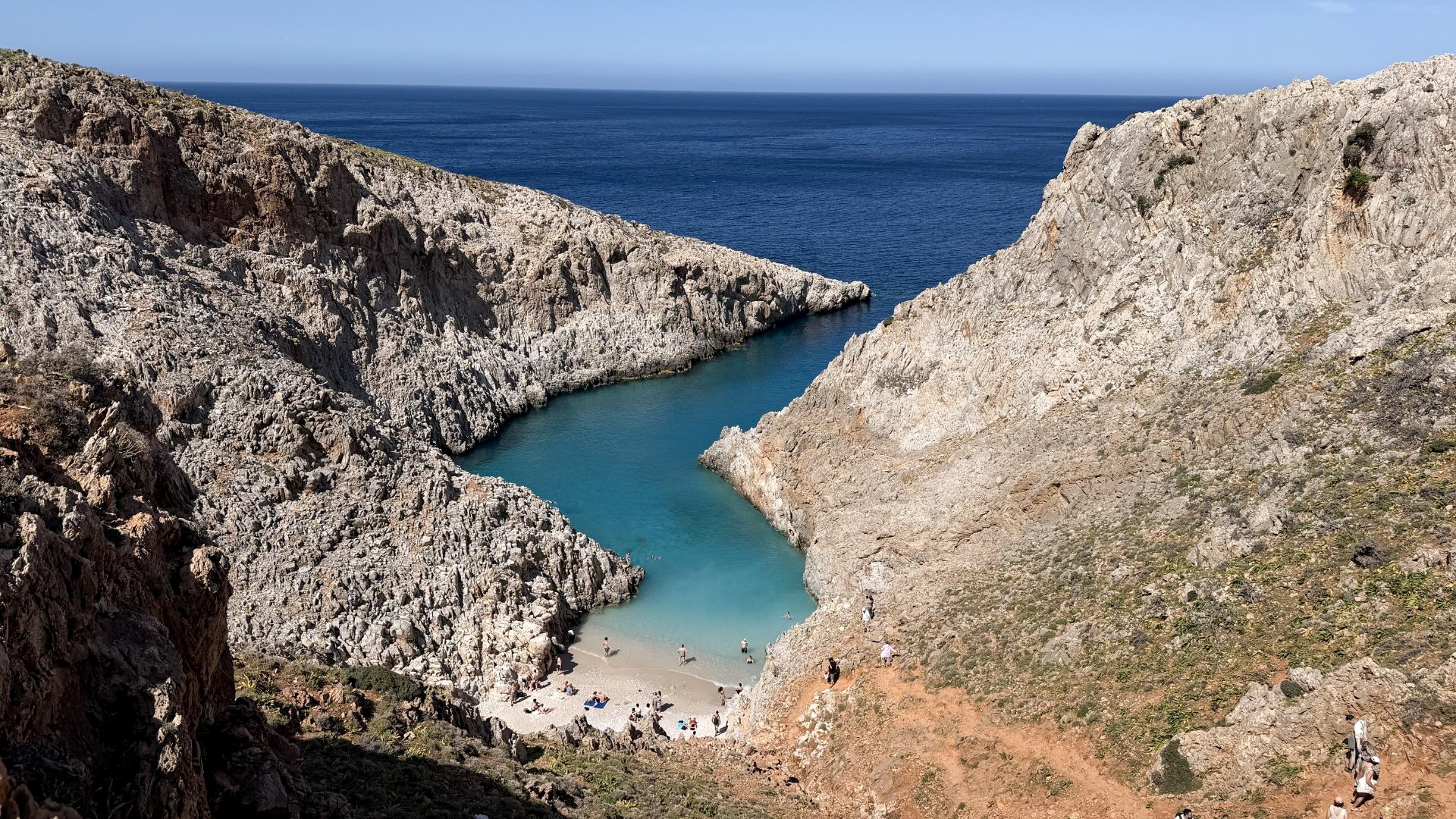 Aerial view of Seitan Limania beach hidden between dramatic rocky cliffs in Crete