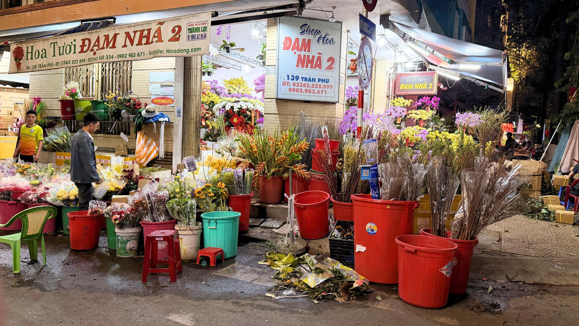 Traditional Tet flower market in Da Nang, Vietnam filled with colorful flowers and local vendors at night. Traditional Tet flower market in Da Nang, Vietnam filled with colorful flowers and local vendors at night.