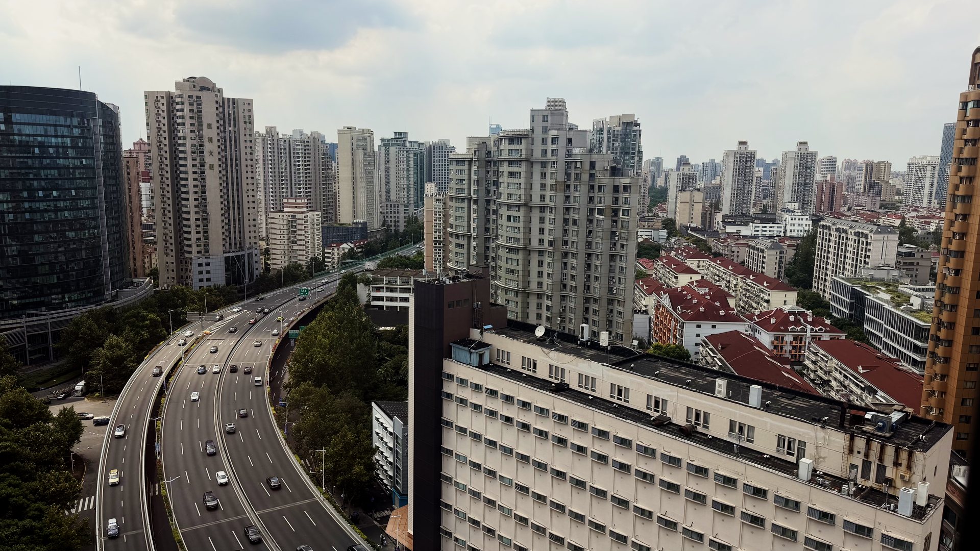 Elevated highway curving between high-rise apartment blocks in Shanghai Elevated highway curving between high-rise apartment blocks in Shanghai