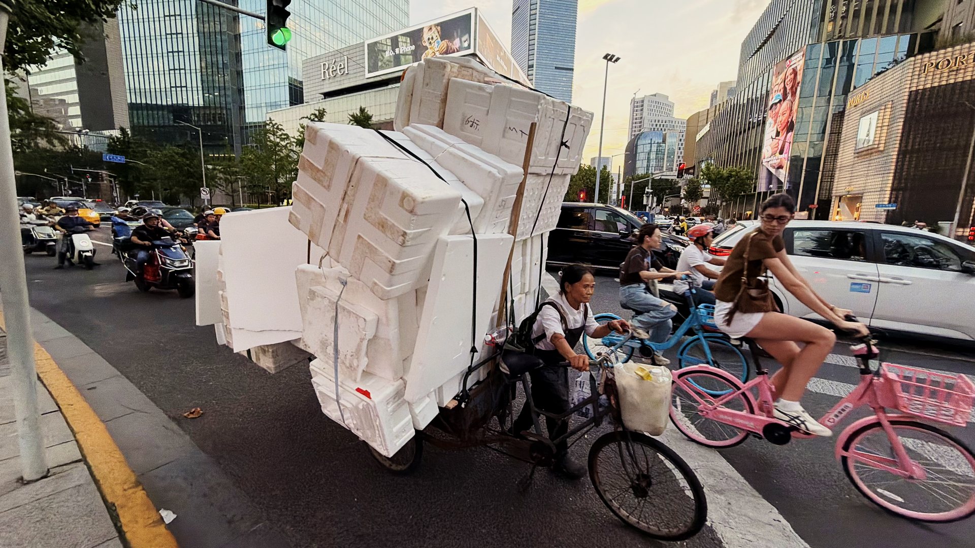 A tricycle piled high with foam boxes in Shanghai traffic A tricycle piled high with foam boxes in Shanghai traffic